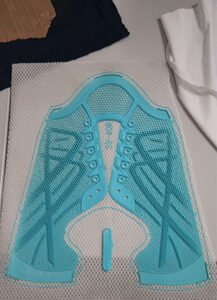 Warp-knitted footwear fabric with 3D-printed reinforcement structure